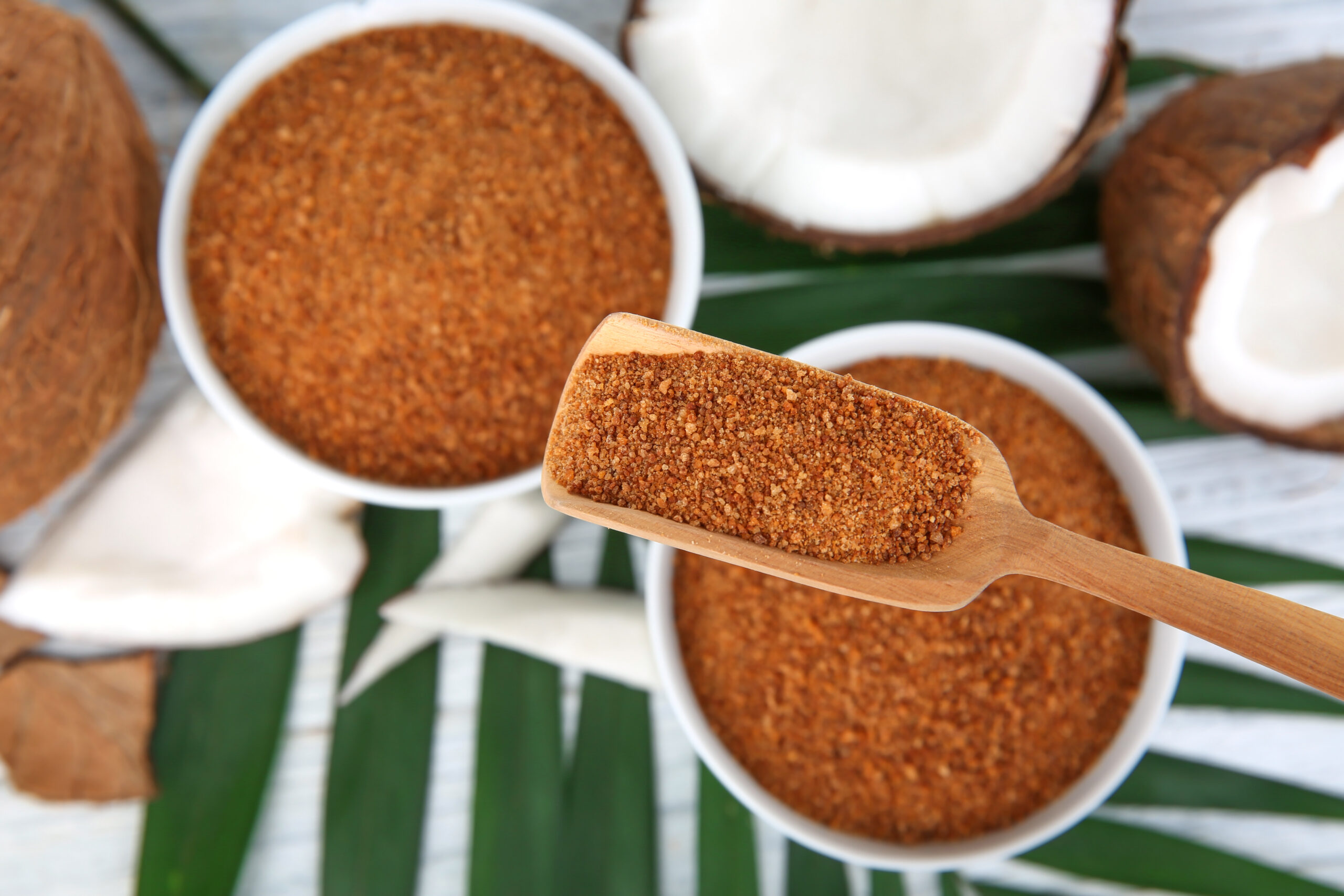Bowls and scoop of coconut sugar on wooden background Sucre de coco bio en vrac pour industrie alimentaire et private label Kaskade